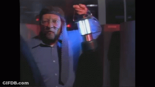 Man In Blue Shirt Holding Lantern GIF