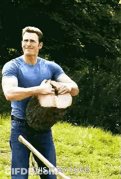 Man In Blue Shirt Holding Log And Shovel GIF