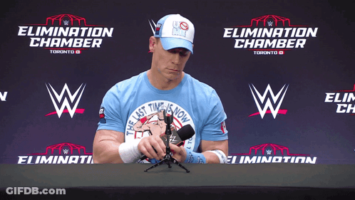 Man In Blue Shirt Holding Microphone GIF