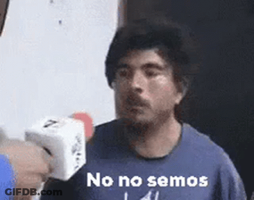 Man In Blue Shirt Holding Microphone Saying No No Semos GIF