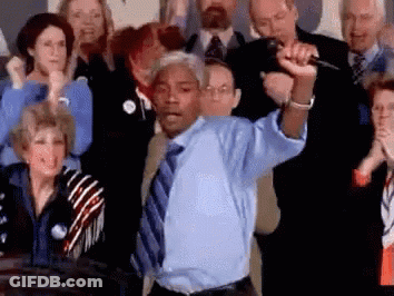 Man In Blue Shirt Holding Microphone To Crowd GIF