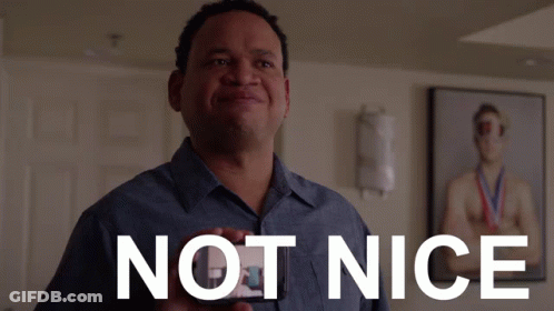 Man In Blue Shirt Holding Not Nice Card GIF