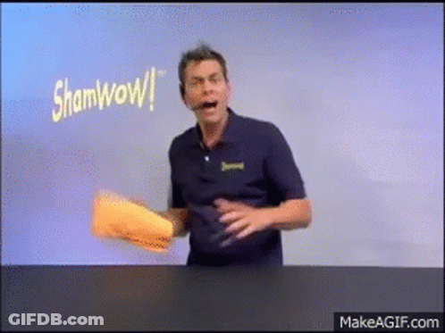 Man In Blue Shirt Holding Paper Saying Shamwow GIF