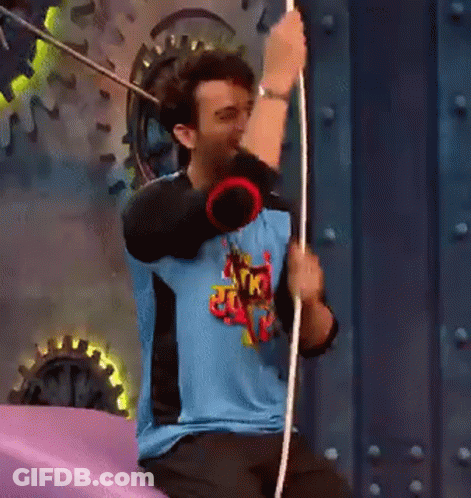 Man In Blue Shirt Holding Rope On Purple Surface GIF