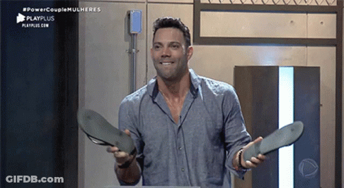 Man In Blue Shirt Holding Sandals GIF