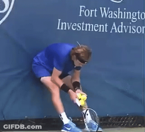Man In Blue Shirt Holding Tennis Racket And Ball GIF