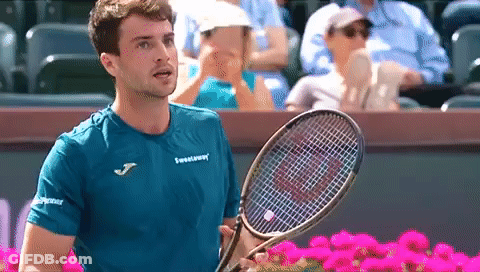 Man In Blue Shirt Holding Tennis Racquet GIF