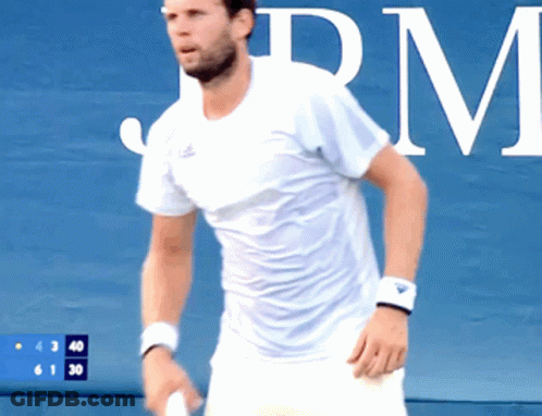 Man In Blue Shirt Holding Tennis Racquet Near Masimo Wall GIF