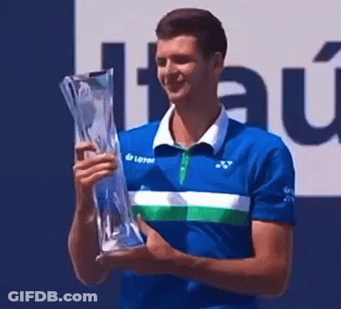 Man In Blue Shirt Holding Trophy And Smiling GIF