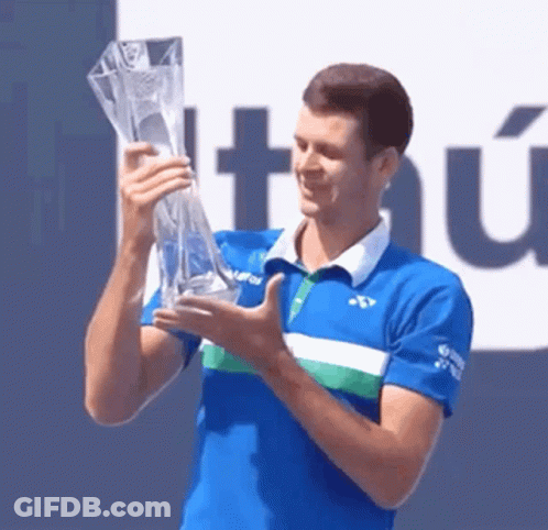 Man In Blue Shirt Holding Trophy GIF
