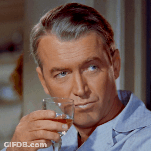 Man In Blue Shirt Holding Wine Glass GIF