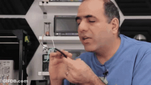 Man In Blue Shirt Holding Wire GIF