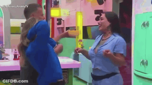 Man In Blue Shirt Holding Woman In Kitchen GIF