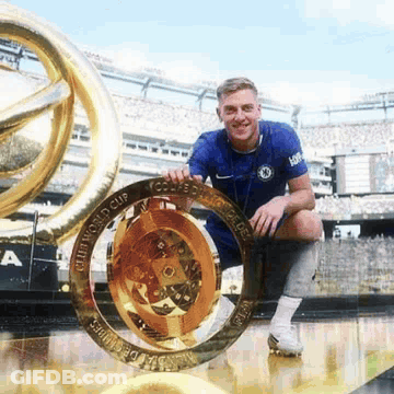 Man In Blue Shirt Holding World Cup Trophy GIF