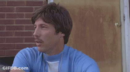 Man In Blue Shirt How Much You Wanna Bet I Could Throw A Football Over Them Mouthains GIF