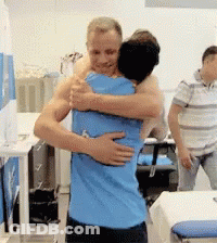 Man In Blue Shirt Hugging Another Man In Hospital GIF