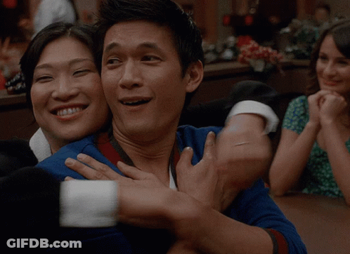 Man In Blue Shirt Hugging Woman In Green Dress GIF