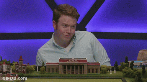 Man In Blue Shirt In Front Of Agleport College Model GIF