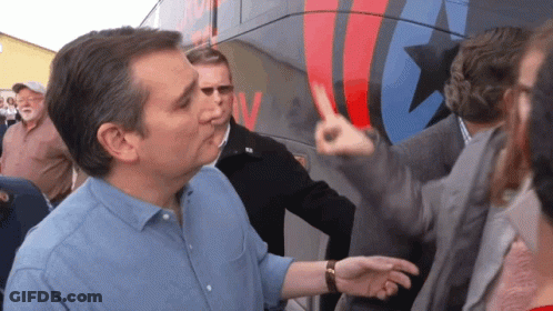 Man In Blue Shirt In Front Of Bus Saying NV GIF