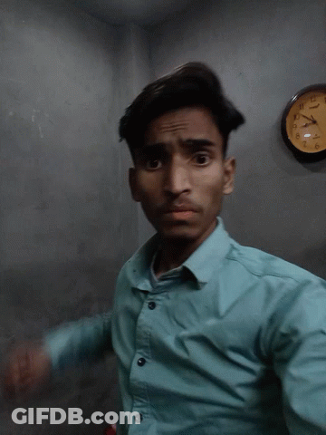 Man In Blue Shirt In Front Of Casio Clock GIF