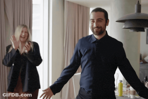 Man In Blue Shirt In Front Of Clapping Woman GIF