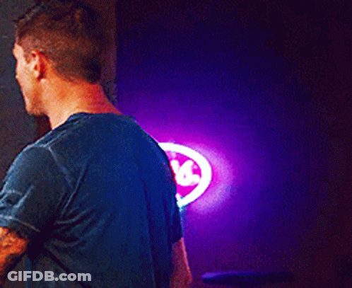Man In Blue Shirt In Front Of Coors Sign GIF