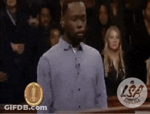 Man In Blue Shirt In Front Of Crowd With LSA Audience Logo GIF