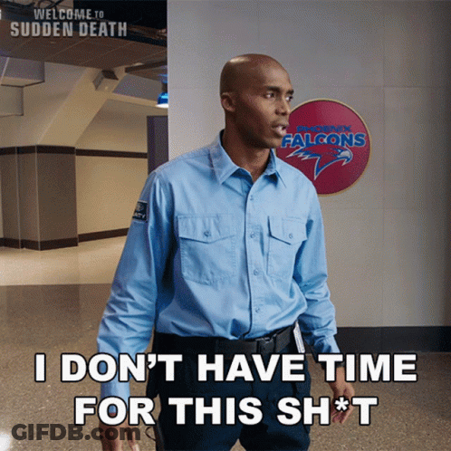 Man In Blue Shirt In Front Of Falcons Sign GIF
