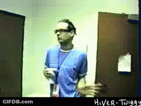 Man In Blue Shirt In Front Of Hiver-Twigg Door GIF