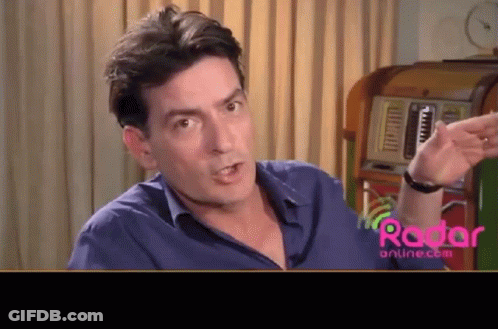 Man In Blue Shirt In Front Of Jukebox GIF