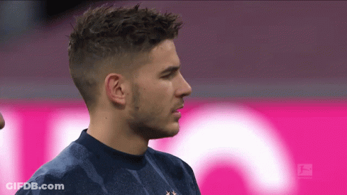 Man In Blue Shirt In Front Of Pink T-Mobile Sign GIF