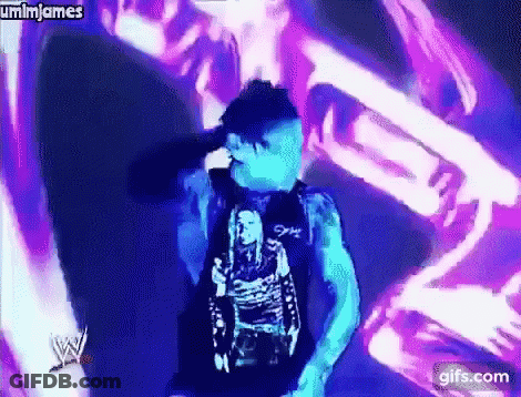 Man In Blue Shirt In Front Of Purple And Blue Background GIF