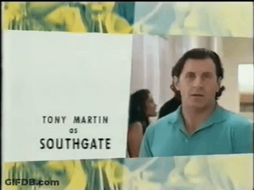 Man In Blue Shirt In Front Of Tony Martin Southgate Sign GIF