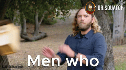 Man In Blue Shirt In Front Of Trees Men Who Are On Screen GIF