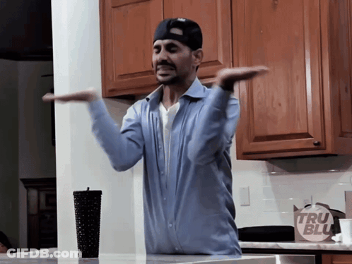 Man In Blue Shirt In Front Of Tru Blue Bag GIF
