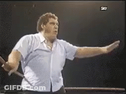 Man In Blue Shirt In Front Of TV Saying Sky GIF