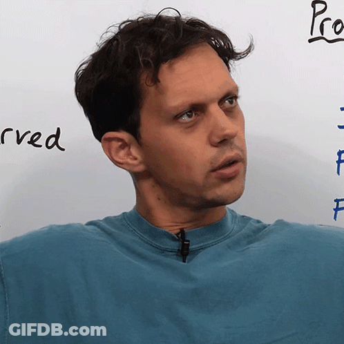 Man In Blue Shirt In Front Of Whiteboard Saying Pro GIF