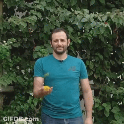 Man In Blue Shirt Juggling Ball On Head GIF