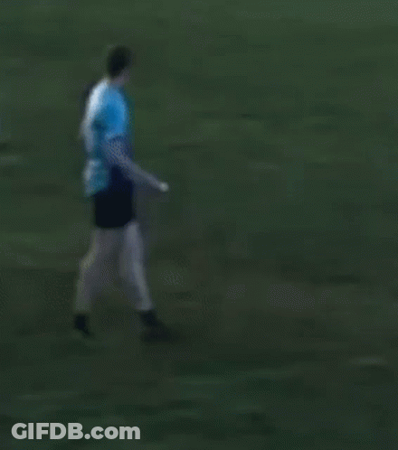 Man In Blue Shirt Kicking Frisbee GIF