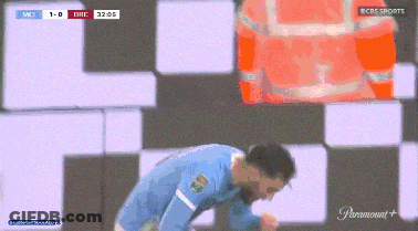 Man In Blue Shirt Kneeling Before CBS Sports Sign GIF