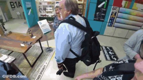 Man In Blue Shirt Kneeling Before Farba Specialty Sign GIF
