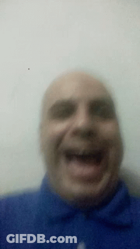Man In Blue Shirt Laughing With Mouth Open GIF