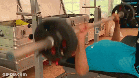 Man In Blue Shirt Lifting Barbell In Gym GIF
