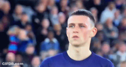 Man In Blue Shirt Looking At Camera GIF