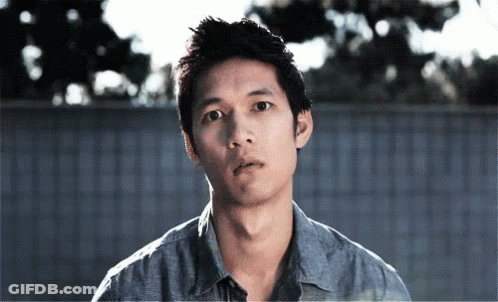 Man In Blue Shirt Looking At Camera GIF