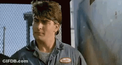 Man In Blue Shirt Looking At Camera GIF