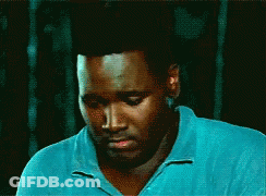 Man In Blue Shirt Looking Down Eyes Closed GIF