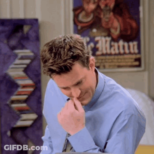 Man In Blue Shirt Looking Down In Front Of Le Matua Poster GIF