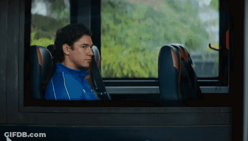 Man In Blue Shirt Looking Out Bus Window GIF