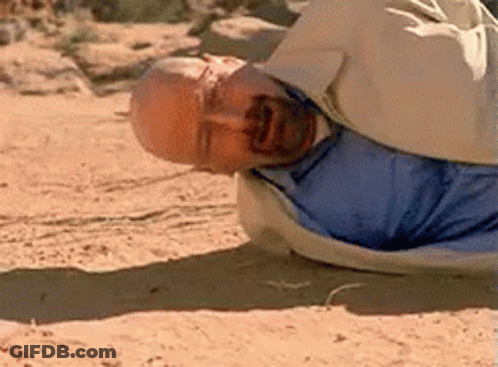 Man In Blue Shirt Lying On Sand GIF